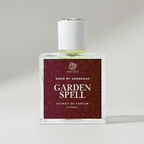 Perfume bottle labeled 'Garden Spell' on a beige background