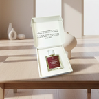 Perfume bottle labeled 'Garden Spell' in an open box on a marble surface.